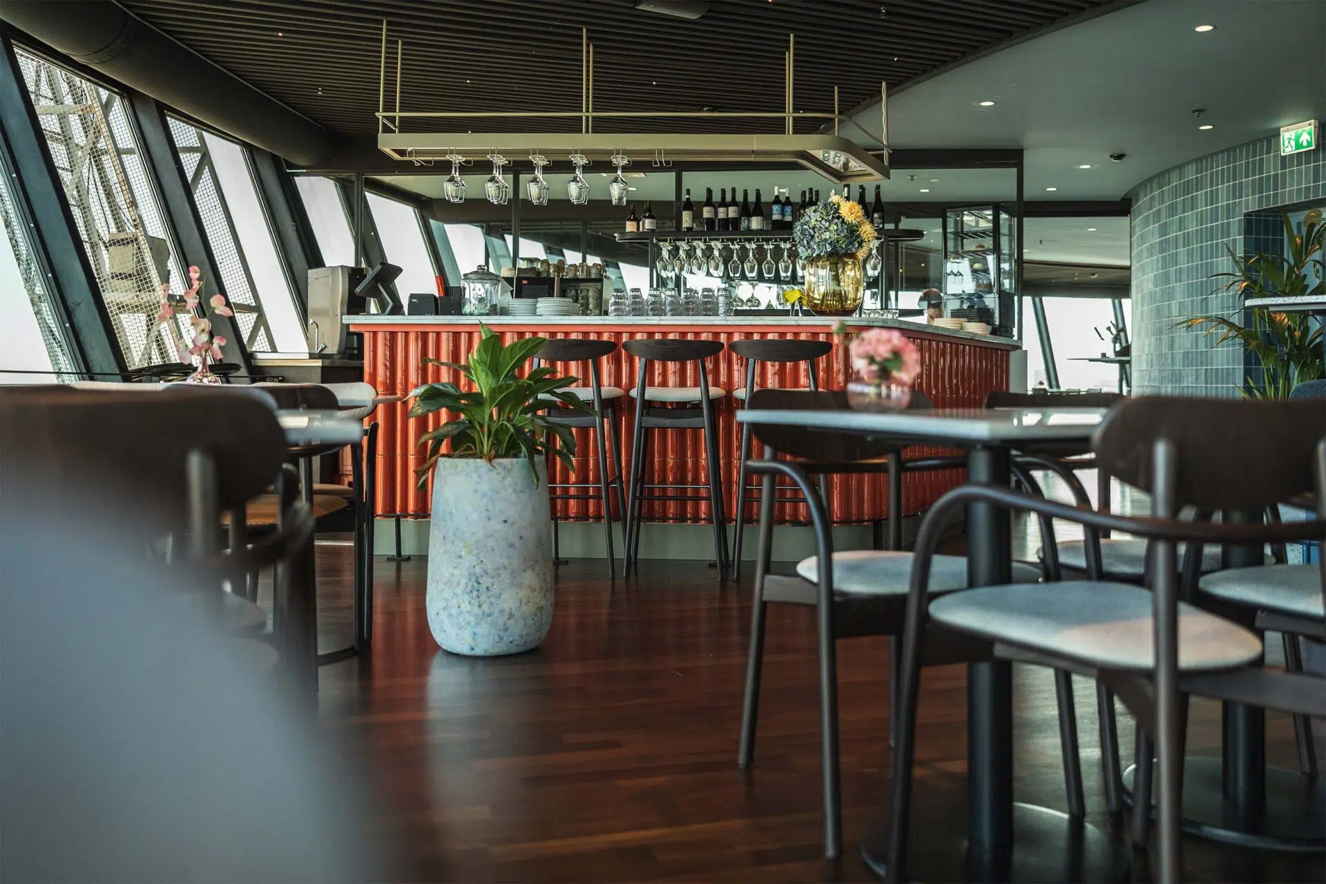 Bar with upholstered bar stools and tables in the restaurant of the Euromast